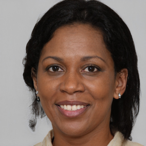Joyful black adult female with medium  black hair and brown eyes