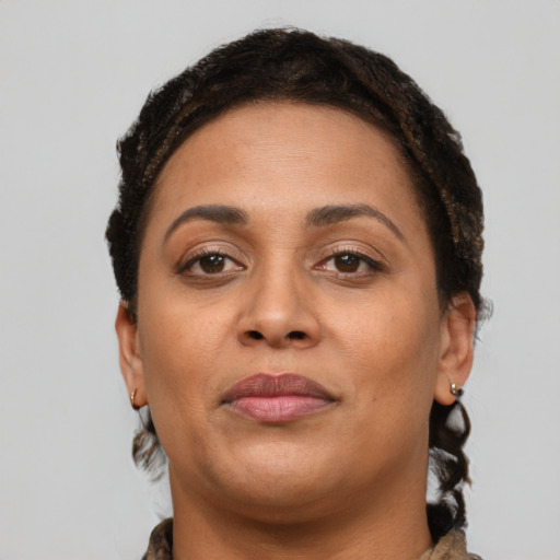 Joyful latino young-adult female with short  brown hair and brown eyes