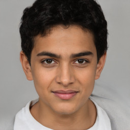 Joyful latino young-adult male with short  brown hair and brown eyes