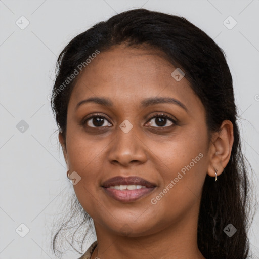 Joyful black young-adult female with long  brown hair and brown eyes