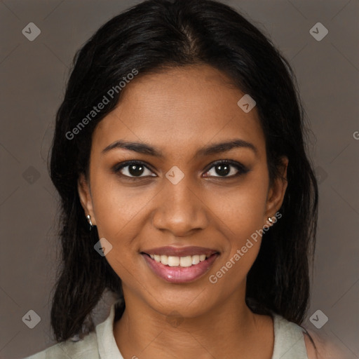 Joyful black young-adult female with medium  black hair and brown eyes