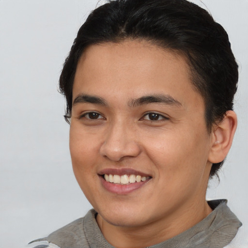 Joyful asian young-adult female with short  brown hair and brown eyes