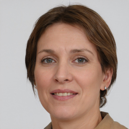 Joyful white young-adult female with medium  brown hair and green eyes