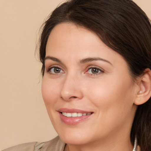 Joyful white young-adult female with medium  brown hair and brown eyes