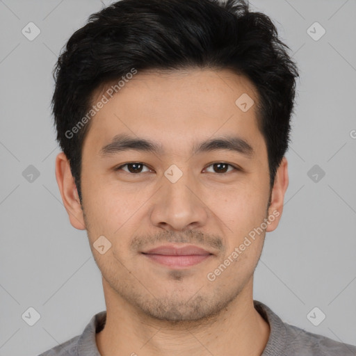 Joyful asian young-adult male with short  black hair and brown eyes