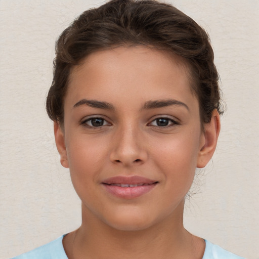 Joyful white child female with short  brown hair and brown eyes