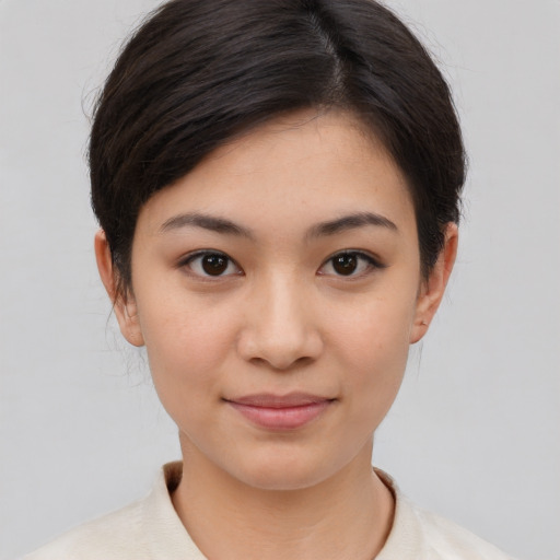 Joyful asian young-adult female with short  brown hair and brown eyes