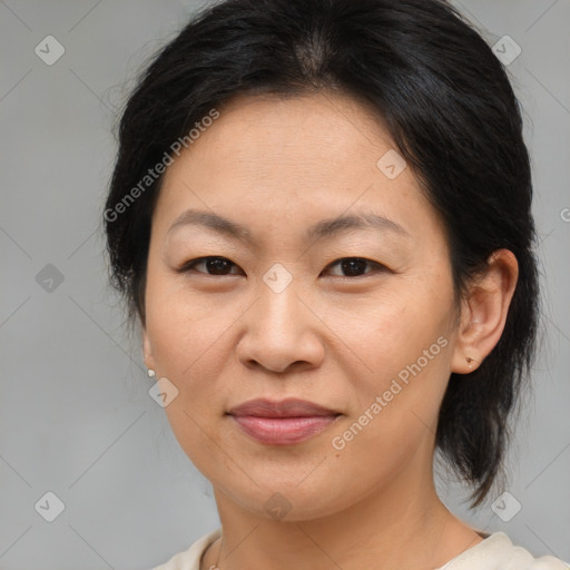 Joyful asian adult female with medium  brown hair and brown eyes