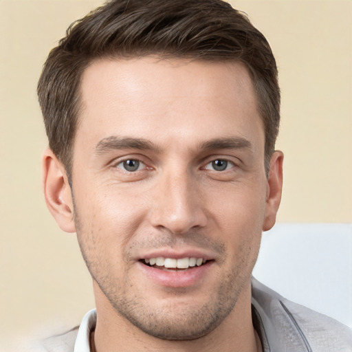 Joyful white young-adult male with short  brown hair and brown eyes