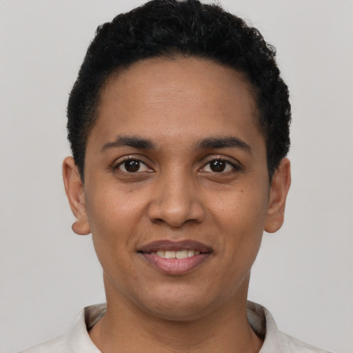 Joyful latino young-adult female with short  black hair and brown eyes