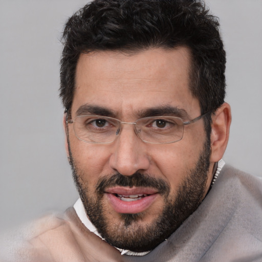 Joyful white adult male with short  black hair and brown eyes