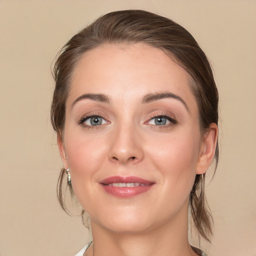 Joyful white young-adult female with medium  brown hair and blue eyes