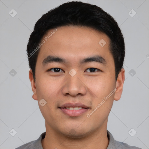 Joyful asian young-adult male with short  black hair and brown eyes