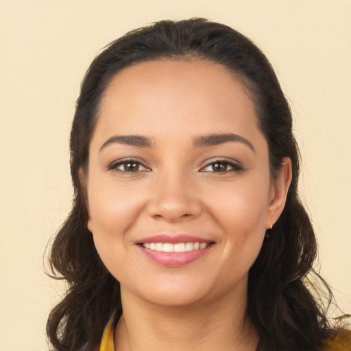 Joyful latino young-adult female with long  brown hair and brown eyes