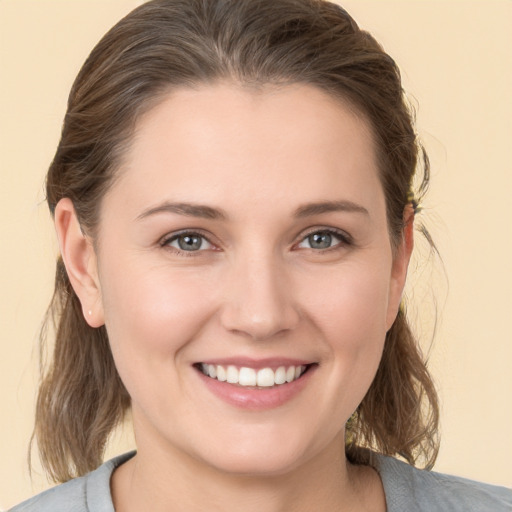 Joyful white young-adult female with medium  brown hair and brown eyes