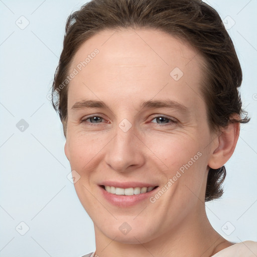 Joyful white young-adult female with short  brown hair and grey eyes