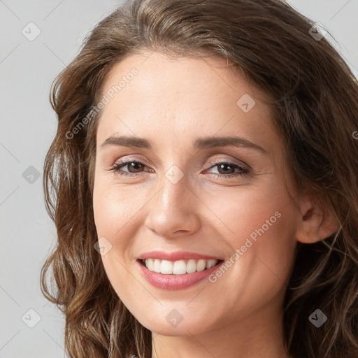 Joyful white young-adult female with long  brown hair and grey eyes