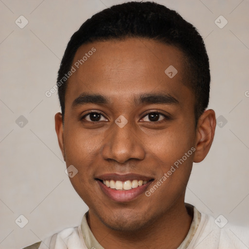 Joyful black young-adult male with short  black hair and brown eyes