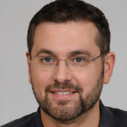 Joyful white adult male with short  brown hair and brown eyes