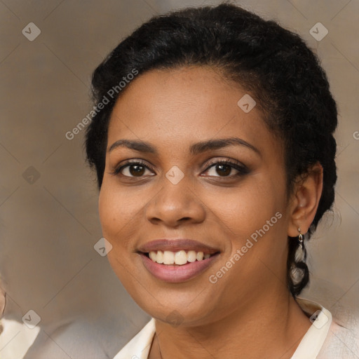 Joyful black young-adult female with short  brown hair and brown eyes