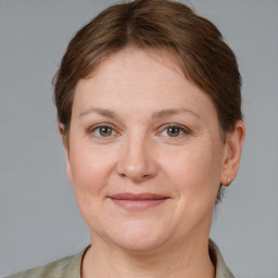 Joyful white adult female with short  brown hair and grey eyes