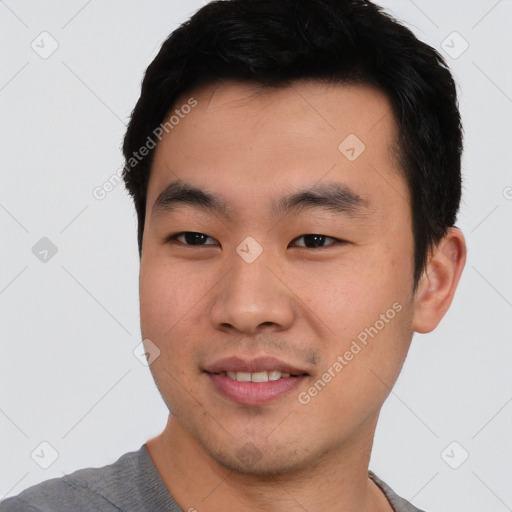 Joyful asian young-adult male with short  black hair and brown eyes