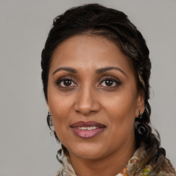 Joyful black adult female with medium  brown hair and brown eyes