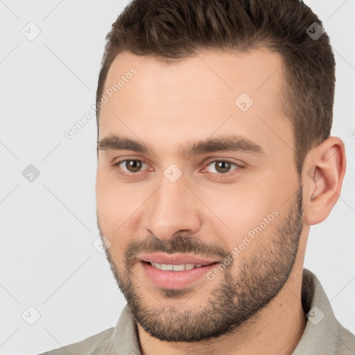 Joyful white young-adult male with short  brown hair and brown eyes