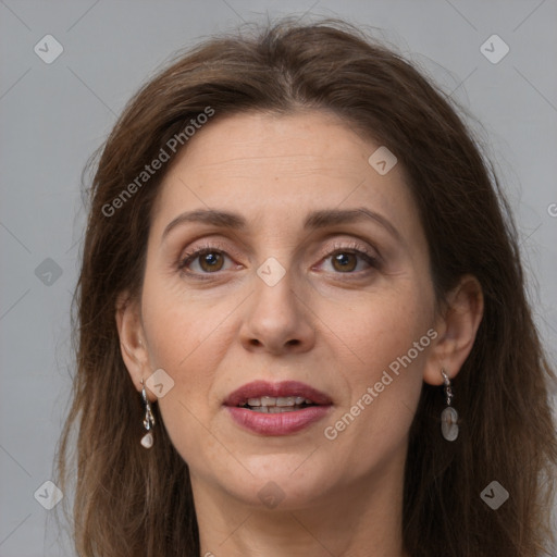 Joyful white adult female with long  brown hair and grey eyes