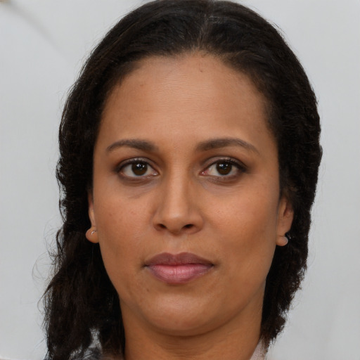 Neutral latino adult female with long  brown hair and brown eyes
