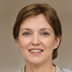 Joyful white adult female with medium  brown hair and grey eyes