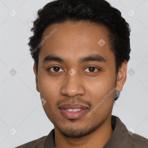Joyful latino young-adult male with short  black hair and brown eyes
