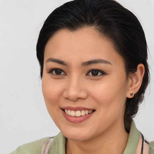Joyful asian young-adult female with medium  brown hair and brown eyes