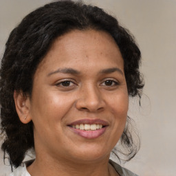 Joyful black adult female with medium  brown hair and brown eyes