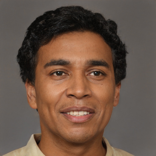 Joyful latino adult male with short  black hair and brown eyes