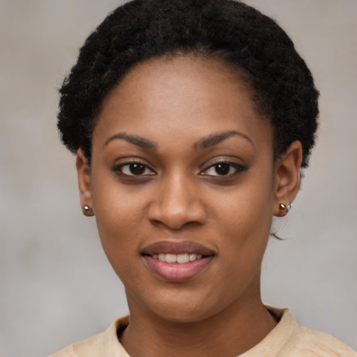 Joyful black young-adult female with short  black hair and brown eyes