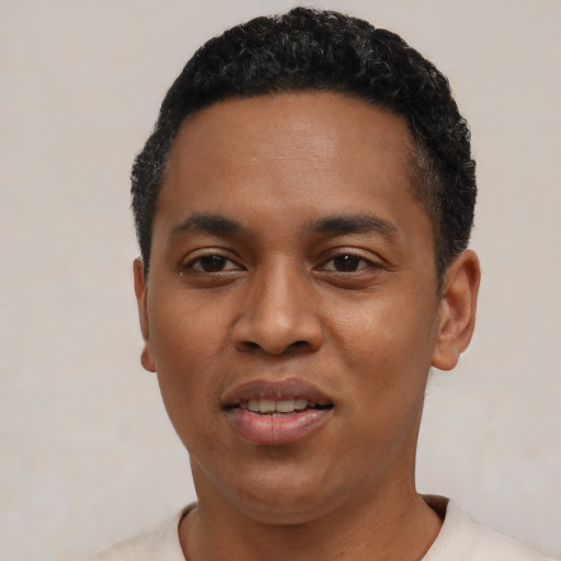 Joyful black young-adult male with short  black hair and brown eyes