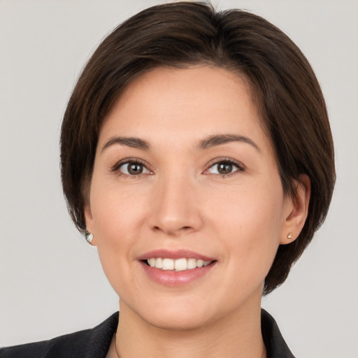 Joyful white young-adult female with medium  brown hair and brown eyes