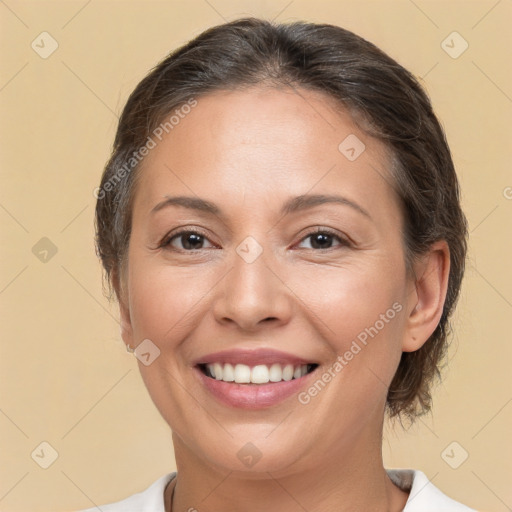 Joyful white adult female with medium  brown hair and brown eyes