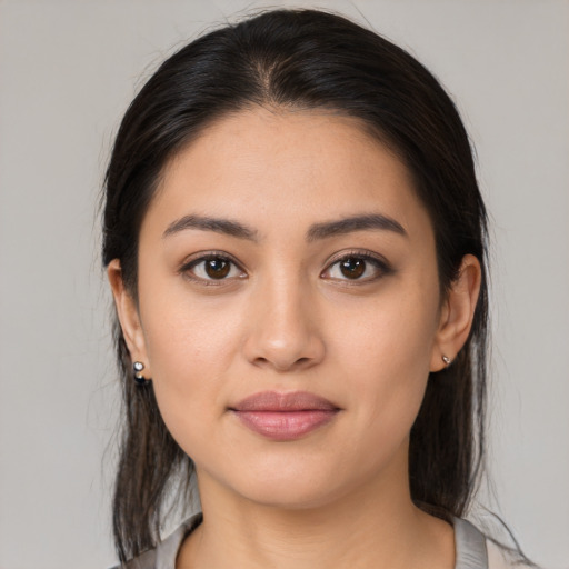 Joyful latino young-adult female with medium  brown hair and brown eyes