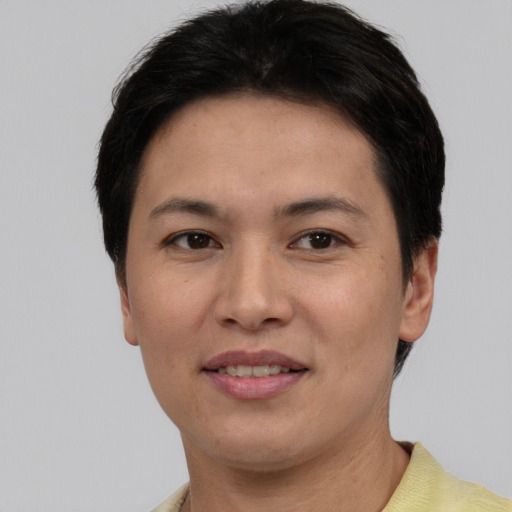 Joyful white young-adult female with short  black hair and brown eyes