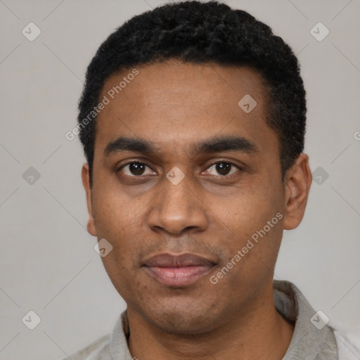 Joyful black young-adult male with short  black hair and brown eyes