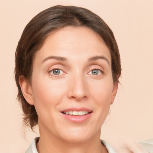 Joyful white young-adult female with medium  brown hair and green eyes