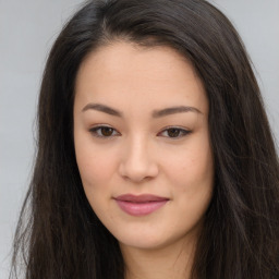 Joyful asian young-adult female with long  brown hair and brown eyes