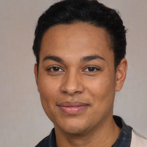 Joyful latino young-adult male with short  black hair and brown eyes