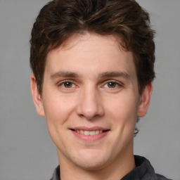 Joyful white adult male with short  brown hair and grey eyes