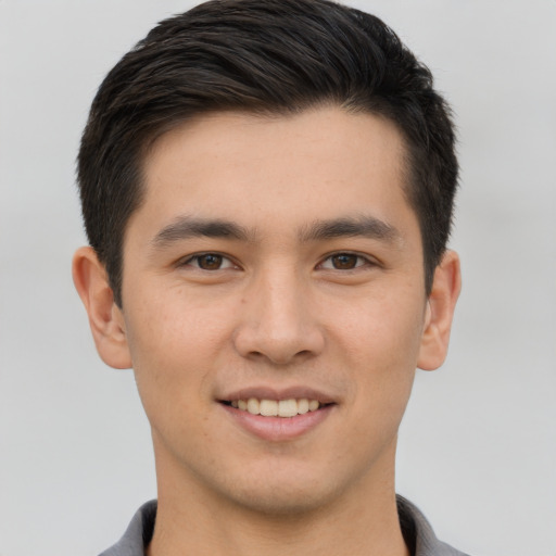 Joyful asian young-adult male with short  brown hair and brown eyes