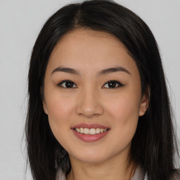 Joyful asian young-adult female with long  brown hair and brown eyes