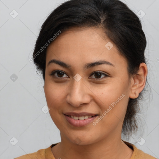 Joyful latino young-adult female with medium  brown hair and brown eyes