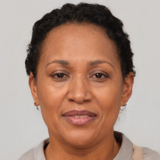 Joyful latino adult female with short  brown hair and brown eyes